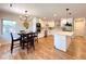 Beautiful eat-in kitchen with stainless appliances, large island, and modern light fixtures at 9451 E Evans Pl, Denver, CO 80231