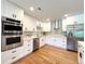 Updated kitchen features stainless appliances, quartz countertops, and sleek cabinetry at 9451 E Evans Pl, Denver, CO 80231