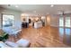 Open-concept layout featuring hardwood floors connecting the living area, kitchen, and dining space at 9451 E Evans Pl, Denver, CO 80231