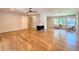 Bright living room featuring hardwood floors, a modern fireplace, and large windows for ample natural light at 9451 E Evans Pl, Denver, CO 80231