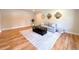Comfortable living room featuring hardwood floors, a plush sofa, and decorative accents at 9451 E Evans Pl, Denver, CO 80231