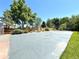 Spacious, private tennis court with a well-maintained playing surface and surrounded by lush landscaping at 9451 E Evans Pl, Denver, CO 80231