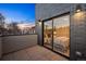 View of bedroom through sliding glass door to balcony with stone flooring and walls, showing cozy interior at 2330 Eliot St # 1, Denver, CO 80211