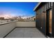 Wide angle view of a rooftop patio featuring gray stone tiles and exterior wall with city views at 2330 Eliot St # 1, Denver, CO 80211