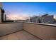 View of city buildings from modern rooftop patio with gray stone tiles and exterior wall at 2330 Eliot St # 1, Denver, CO 80211