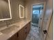 Modern bathroom with double vanity, quartz countertops, and a walk-in shower at 2330 Eliot St # 1, Denver, CO 80211