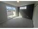 Bright bedroom features neutral gray tones, slider to a private balcony and a decorative accent wall at 2330 Eliot St # 1, Denver, CO 80211