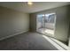 Bright, carpeted bedroom with slider doors to a private balcony offering views of the neighborhood at 2330 Eliot St # 1, Denver, CO 80211