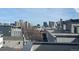 A scenic city view featuring a blue sky, roof tops, and the buildings of the Denver skyline at 2330 Eliot St # 1, Denver, CO 80211