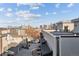 Rooftop view with neighborhood street, garages, and a city skyline under a partly cloudy blue sky at 2330 Eliot St # 1, Denver, CO 80211