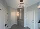 Bright entryway features modern light fixture, accent wall, and gray tile flooring at 2330 Eliot St # 1, Denver, CO 80211