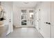 Bright entryway with neutral tile flooring, white walls, and convenient coat closet space at 2330 Eliot St # 1, Denver, CO 80211