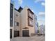 Modern townhome exterior with a two-car garage, sleek finishes, and striking architectural details at 2330 Eliot St # 1, Denver, CO 80211