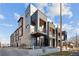 Modern townhome exterior with brick, black metal accents, balconies, and well-maintained landscaping at 2330 Eliot St # 1, Denver, CO 80211