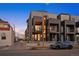 Modern townhome with a balcony, stylish facade, and visible parking; attractive urban living at 2330 Eliot St # 1, Denver, CO 80211