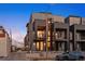 Contemporary townhome featuring brick and metal accents, recessed balconies, and a welcoming entrance at 2330 Eliot St # 1, Denver, CO 80211