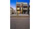 Modern townhome with a balcony, stylish facade, and visible parking; attractive urban living at 2330 Eliot St # 1, Denver, CO 80211