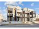 Modern townhomes with recessed balconies and sleek architectural details under a bright sky at 2330 Eliot St # 1, Denver, CO 80211