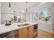 Kitchen island with a sink, light wood cabinets, modern faucet, and large window overlooking the outdoors at 2330 Eliot St # 1, Denver, CO 80211