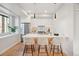 Modern kitchen featuring bar seating, pendant lights, stainless steel appliances, and minimalist white cabinetry at 2330 Eliot St # 1, Denver, CO 80211