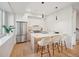 Bright kitchen featuring a stainless steel refrigerator, an island with barstools, and modern pendant lighting at 2330 Eliot St # 1, Denver, CO 80211