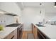 Modern kitchen featuring stainless steel appliances, a gas cooktop, and sleek white cabinetry at 2330 Eliot St # 1, Denver, CO 80211