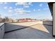 Expansive rooftop patio featuring light stone tiles and exterior wall with city views on a bright day at 2330 Eliot St # 1, Denver, CO 80211