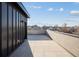 Wide angle view of a rooftop patio featuring light stone tiles and exterior wall with city views at 2330 Eliot St # 1, Denver, CO 80211