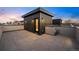 Wide shot of rooftop patio with stone tile, modern exterior and lighting with dusk sky at 2330 Eliot St # 1, Denver, CO 80211