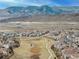 Stunning aerial view of the neighborhood with walking paths and mountain views in the background at 2190 S Poppy St, Lakewood, CO 80228