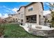 Backyard featuring a patio with fire pit, perfect for outdoor entertainment and relaxation by the grassy lawn at 2190 S Poppy St, Lakewood, CO 80228