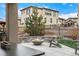 Backyard showcasing a patio with a fire pit and seating area, set against a lush lawn and a well-kept home exterior at 2190 S Poppy St, Lakewood, CO 80228