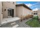 Cozy backyard with a stone patio, green grass, and a charming gravel pathway leading to an outdoor dining area at 2190 S Poppy St, Lakewood, CO 80228