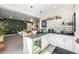 Entertaining bar area with a beverage refrigerator, stylish countertops, and seamless access to the living room at 2190 S Poppy St, Lakewood, CO 80228