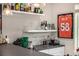 Contemporary basement bar with sleek countertops, open shelving displaying glassware, and ample space for drink preparation at 2190 S Poppy St, Lakewood, CO 80228