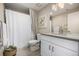 Bright bathroom with a shower, white vanity with grey countertop, a large mirror, and stylish decor at 2190 S Poppy St, Lakewood, CO 80228