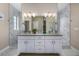 This bathroom features a double sink vanity with marble countertops and tiled floors at 2190 S Poppy St, Lakewood, CO 80228