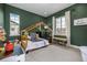 Charming bedroom with green walls, a whimsical house-shaped bed, and playful decor at 2190 S Poppy St, Lakewood, CO 80228