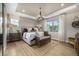 The bedroom is decorated with neutral colors, has large windows and features a tray ceiling at 2190 S Poppy St, Lakewood, CO 80228