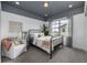 Serene bedroom with an iron bed frame, large window with scenic views, and calming color palette at 2190 S Poppy St, Lakewood, CO 80228