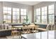 This sun-lit dining area features built-in seating, large windows and a modern table with chairs at 2190 S Poppy St, Lakewood, CO 80228