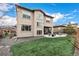 A lush green lawn complements a modern two-story home exterior, featuring well-manicured landscaping at 2190 S Poppy St, Lakewood, CO 80228