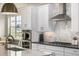 This is a bright kitchen featuring white cabinets, stainless steel appliances, and granite countertops at 2190 S Poppy St, Lakewood, CO 80228