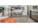 Stylish living area with a built-in bookshelf, floating shelves, a TV, and modern decor at 2190 S Poppy St, Lakewood, CO 80228