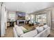 Comfortable living room features a stone fireplace, plush sectional sofa, and sliding glass doors to the outdoor space at 2190 S Poppy St, Lakewood, CO 80228