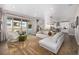 Spacious living area with hardwood floors, comfortable seating, and an open layout connecting to the kitchen and outdoor patio at 2190 S Poppy St, Lakewood, CO 80228