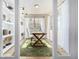 Bright and airy office space featuring custom built-in shelving, natural light, and a unique wooden desk at 2190 S Poppy St, Lakewood, CO 80228