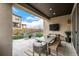 Covered patio area including a dining set, tv and a peaceful view of a well-maintained backyard at 2190 S Poppy St, Lakewood, CO 80228