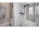 The shower is equipped with a rain shower head and features marble tiling and a glass enclosure at 2190 S Poppy St, Lakewood, CO 80228