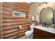 Comfortable bathroom featuring a vessel sink on a wooden vanity and a log-style wall at 57 Overlook Ct, Idaho Springs, CO 80452